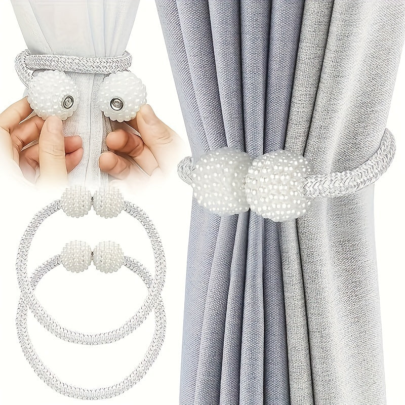 Two pieces of modern style polyester curtain tie backs with a silvery finish. These window drapery holdbacks are perfect for adding a touch of elegance to your home or office decor.