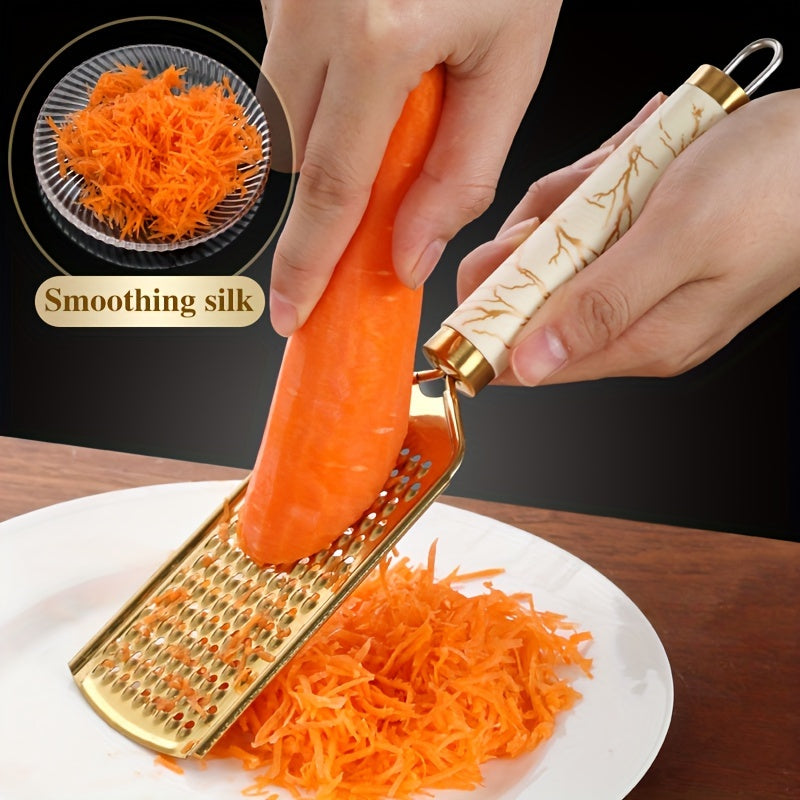 Stainless steel kitchen grater for shredding various foods, with a safe handle and luxurious golden appearance.