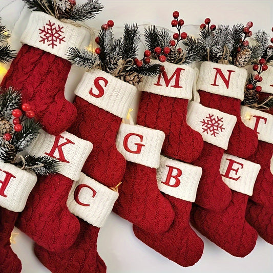 Knitted letter Christmas socks for home tree ornaments; red socks in gift bag for festive attire.