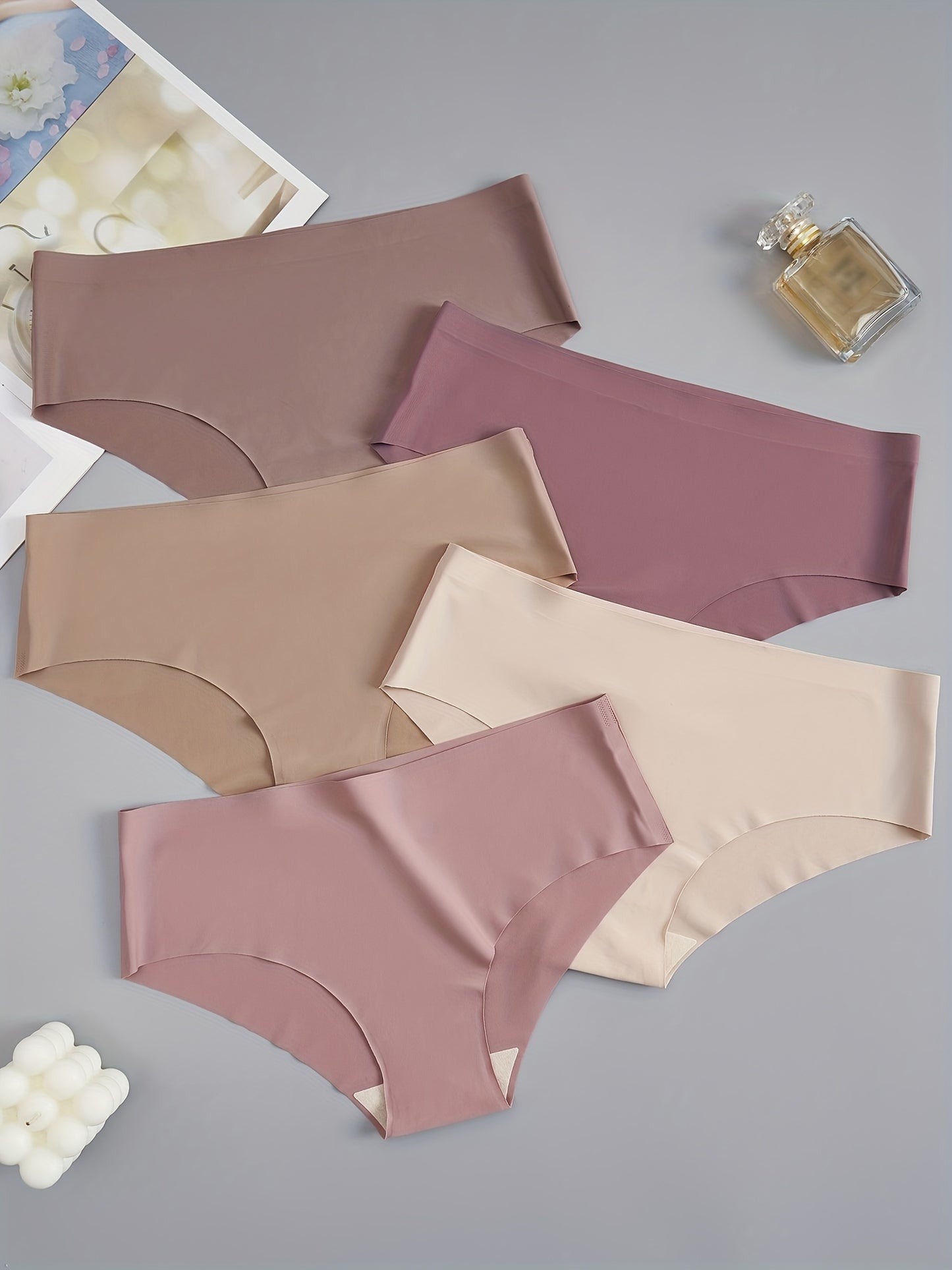 5 seamless women's briefs in assorted brown and purple shades, made from a soft and comfortable nylon blend. Low-rise with a stretch fit, non-see-through material. Comfortable lingerie with