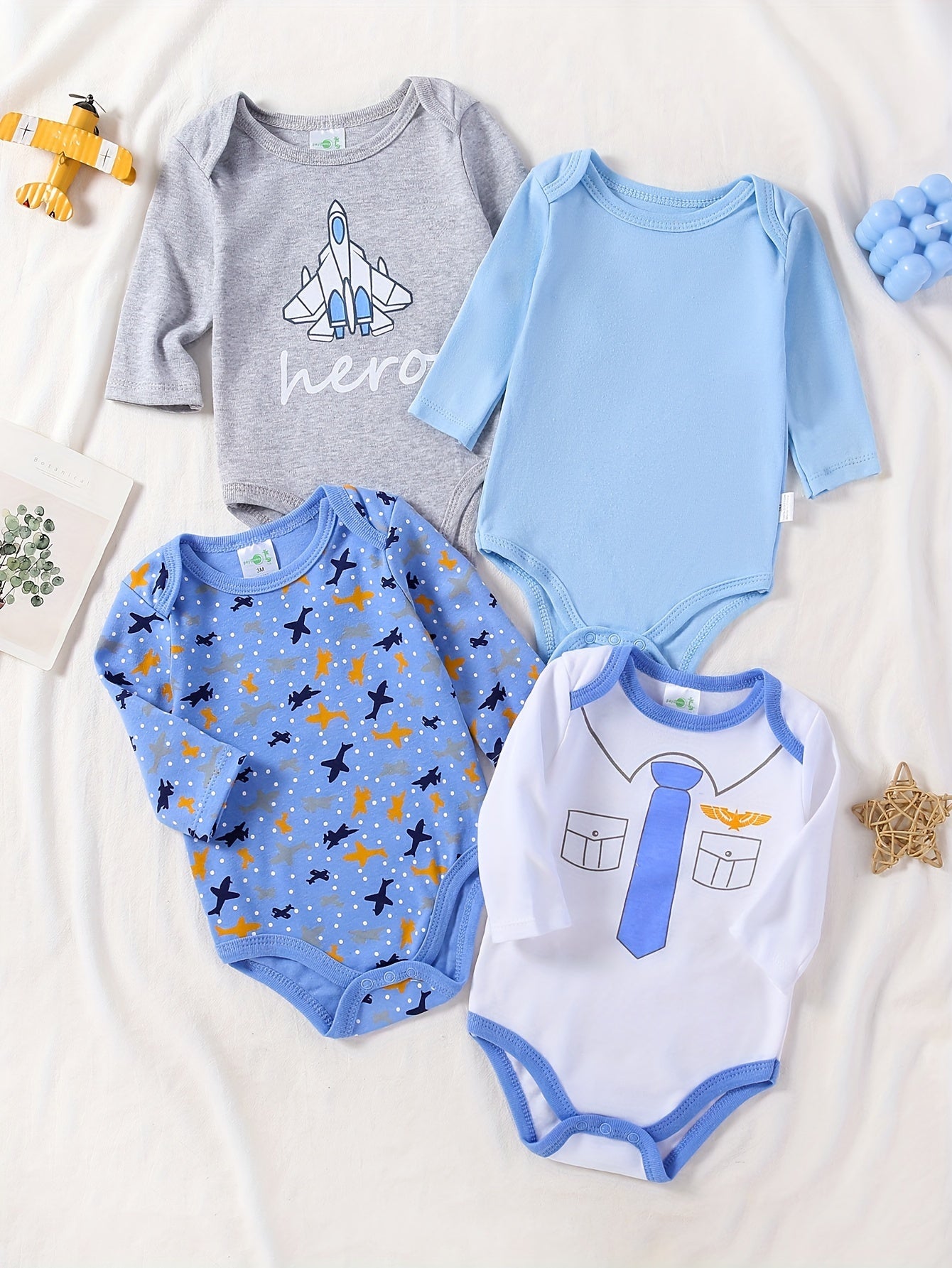 Boys' 4-pack long sleeve cotton onesies with astronaut and space patterns, perfect for fall/winter. Made with knit fabric for a regular fit and slight stretch. Suitable for outdoor wear for