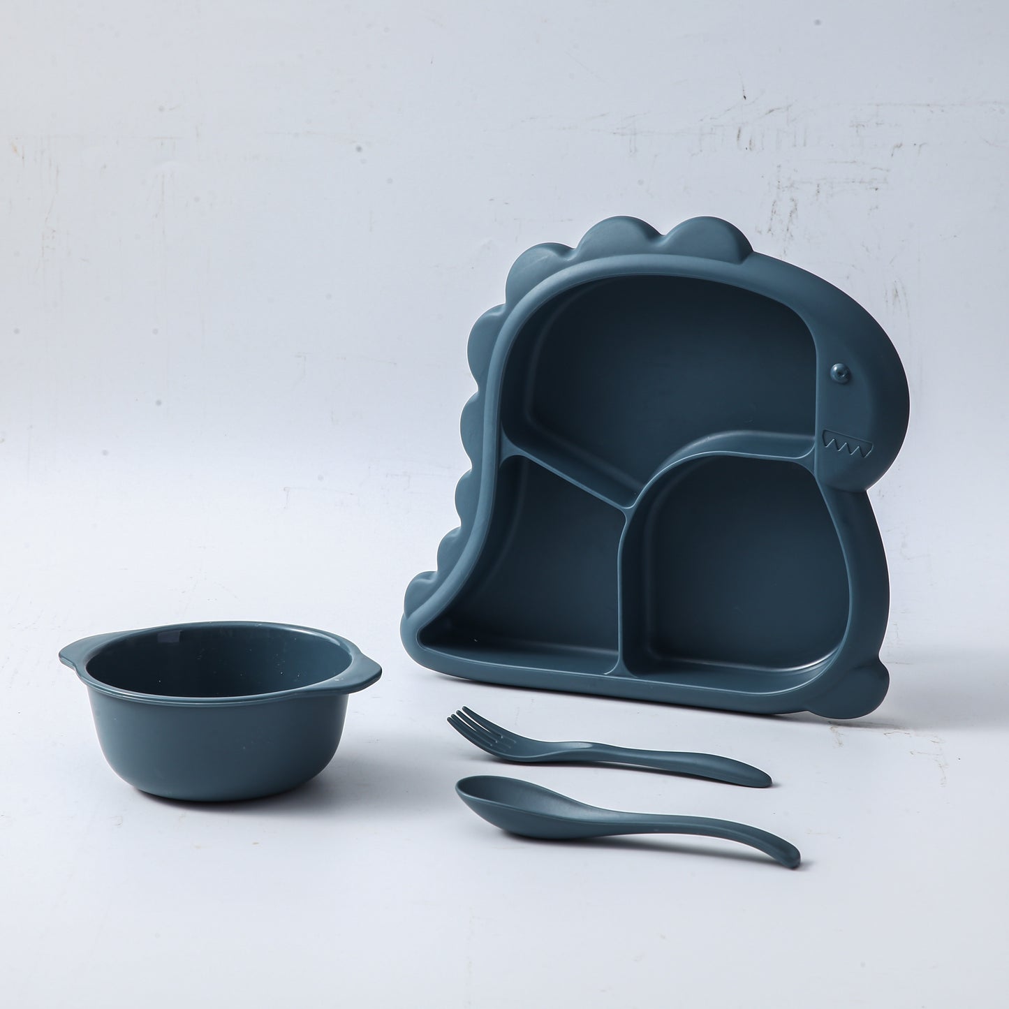 Children's dinnerware set shaped like dinosaurs - made of BPA-free plastic includes plate, bowl, fork, and spoon.