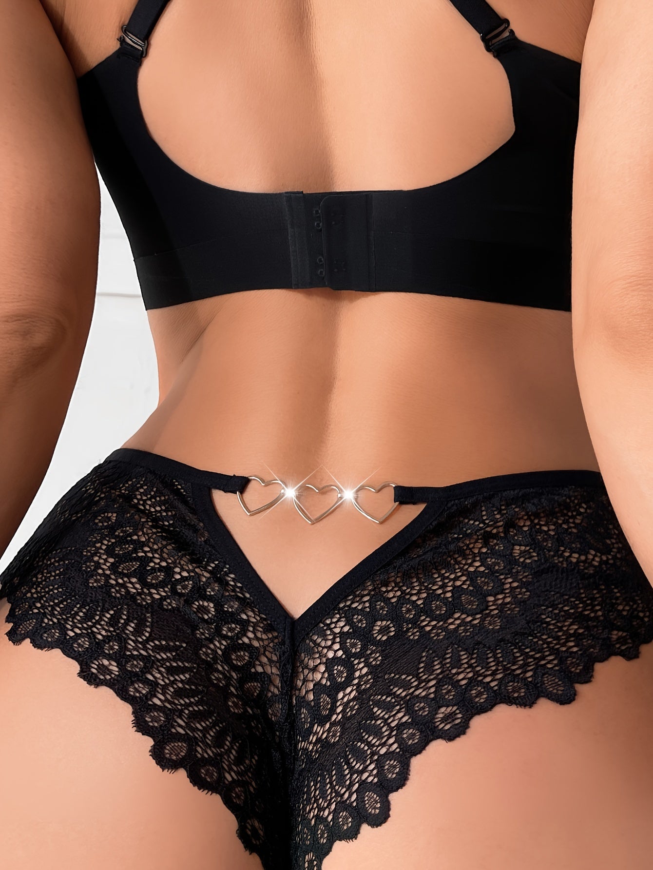 Red lace panties with heart ring detail, lightweight women's underwear made of 90% polyamide and 10% elastane, featuring a V-string style with chain embellishment.