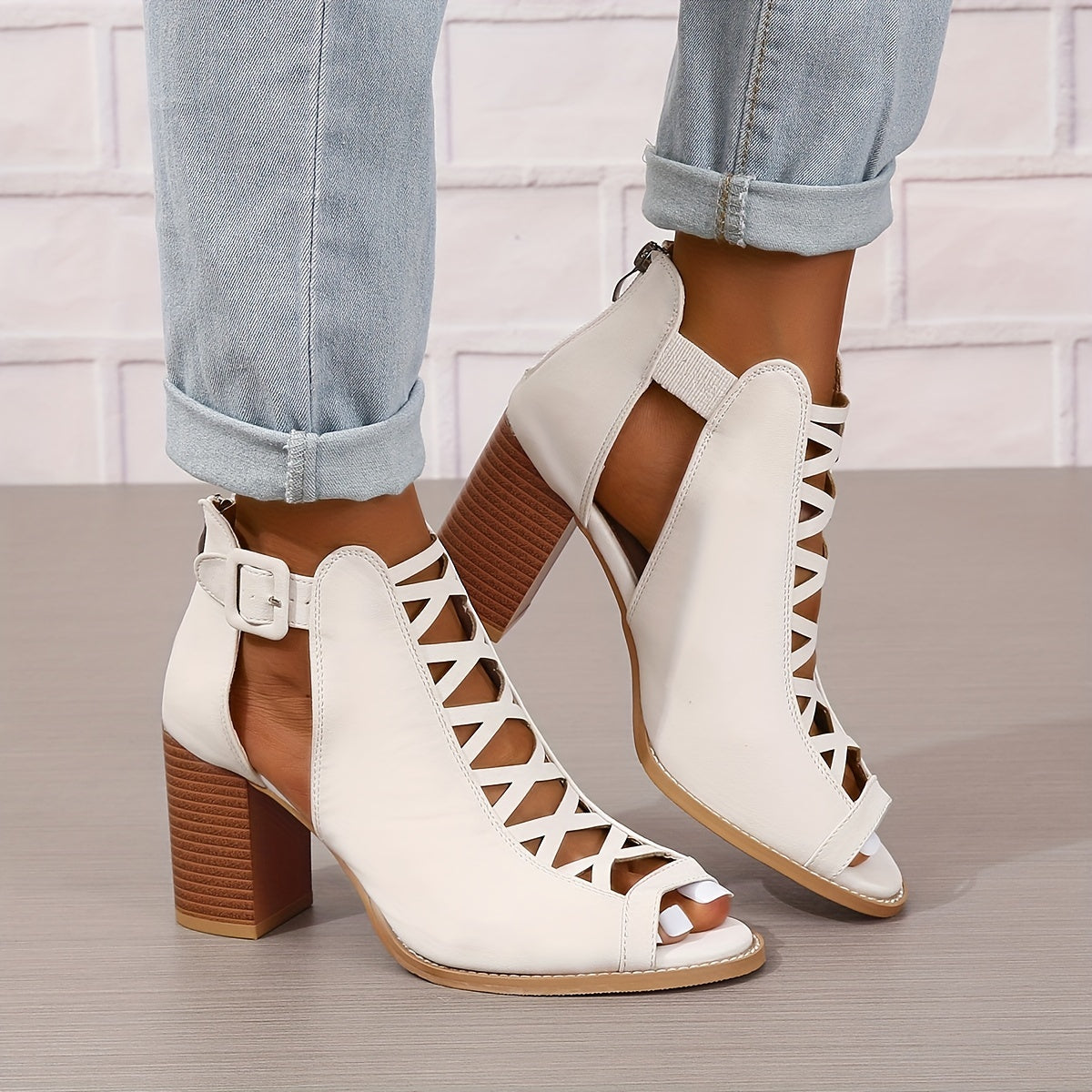 Women's brown faux leather ankle boots with elegant design including peep toe, chunky heel, crisscross straps, and buckle closure. Comfortable summer pumps with rubber sole.