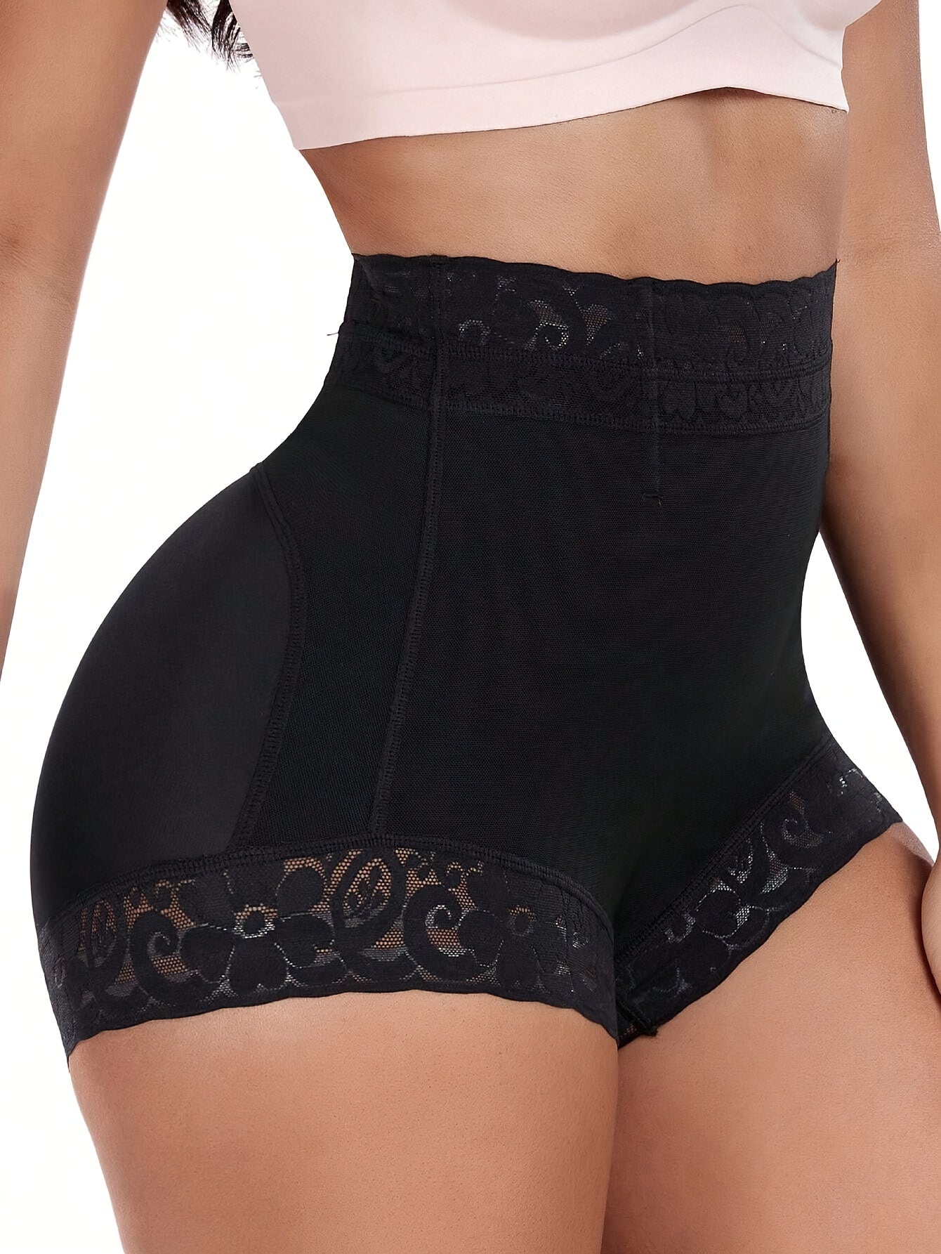 High-waist black shaping shorts with lace detail for tummy control and butt lifting. Made of stretchy nylon and elastane blend. Hand washable with smooth finish. Mid-thigh length and high