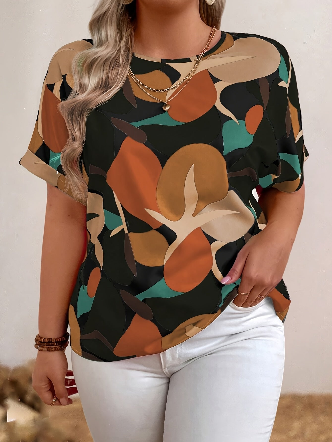 Plus size floral print batwing sleeve blouse in orange, brown & green camouflage design for women. Casual crew neck summer top.