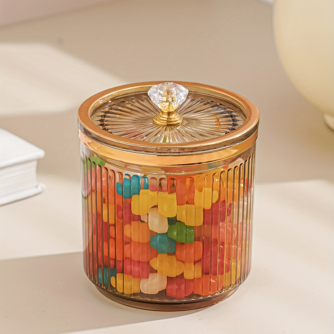 One piece of a transparent amber sketch golden grey bead decorated jar with a lid for candies. Made of plastic, can only be hand washed. It is a reusable sealed fresh-keeping box for storing cereal, rice, pasta, tea, nuts, and coffee beans. Perfect for