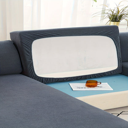 Durable sofa cover protects furniture from spills and stains.