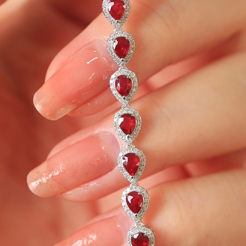 Stylish Sterling Silver Bracelet with Synthetic Red Gemstones and Celestial Theme, featuring zirconia Mosaic. This 925 Silver Plated Jewelry makes a perfect gift for December birthdays, special occasions, or Valentine's Day. A versatile fashion accessory