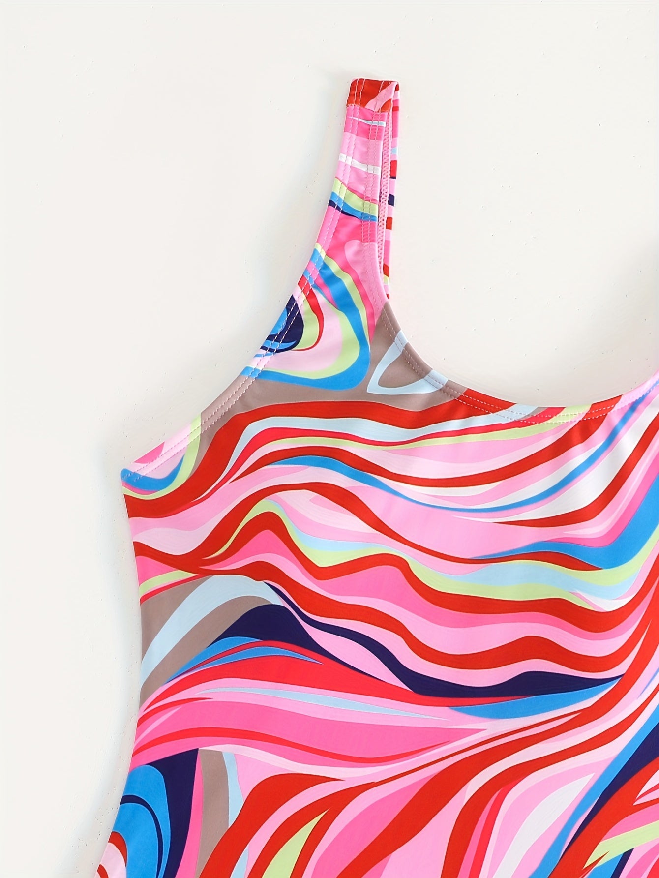 Women's slimming one-piece swimsuit featuring tummy control, colorful abstract print, and athletic style.