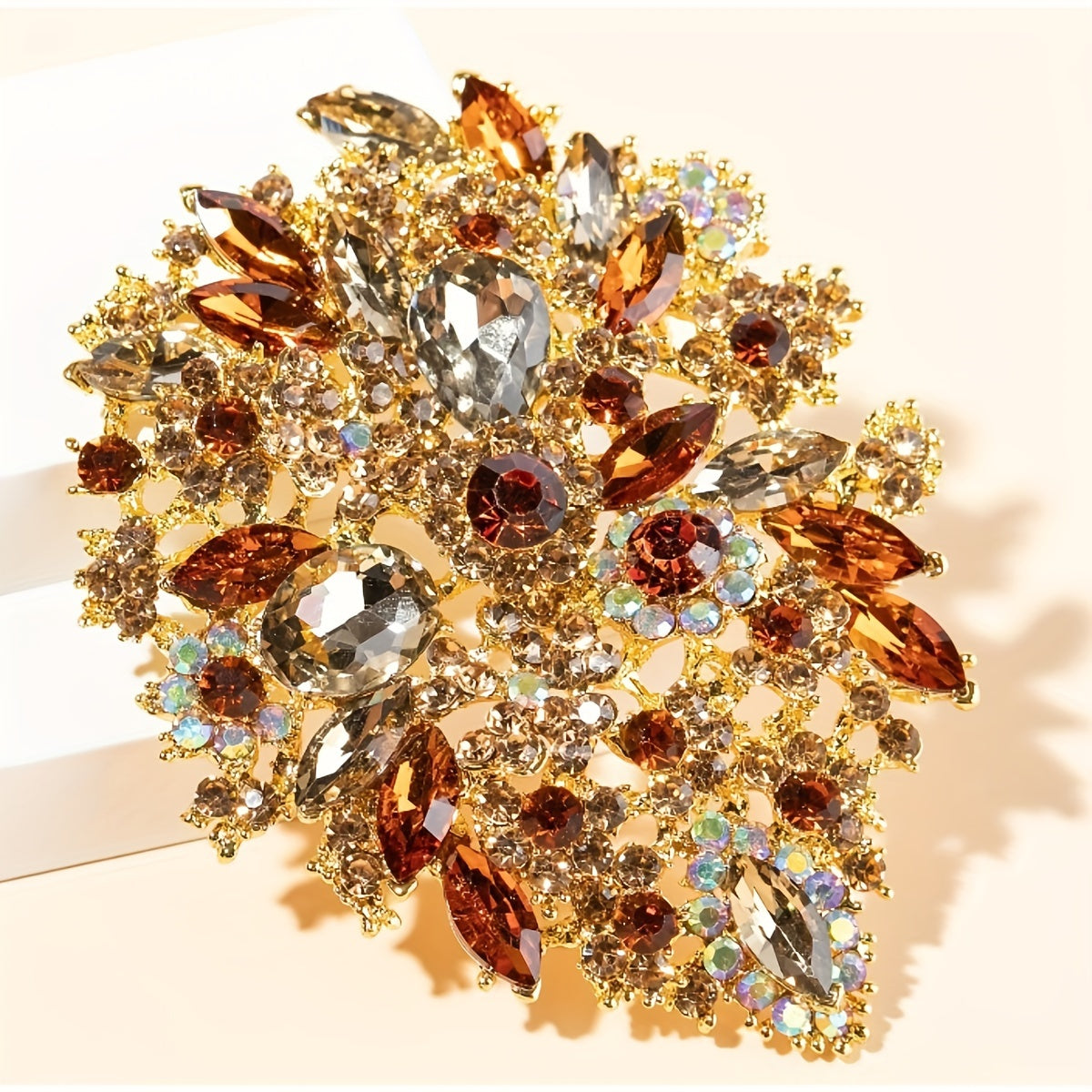 Trsince Brand offers an elegant and luxurious rhinestone brooch pin featuring an irregular shape and gold plated sparkly gemstones, perfect for any woman looking for a unique and stylish accessory.