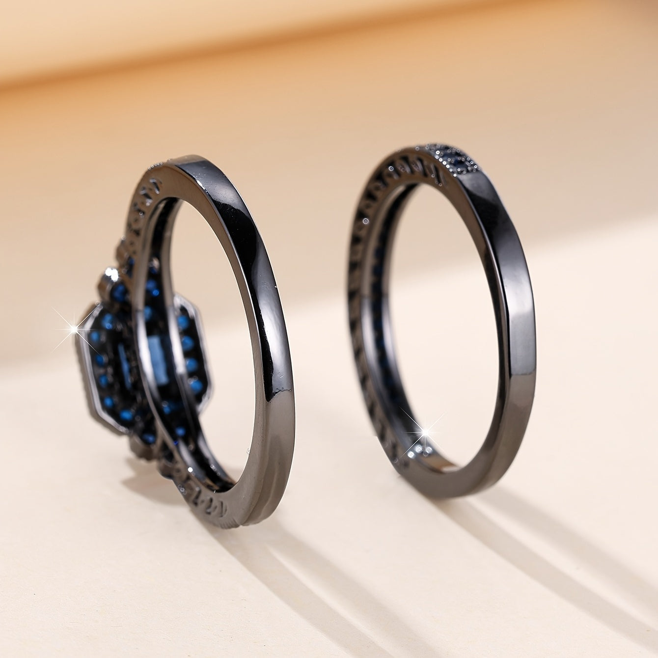 Set of 2 elegant promise rings featuring a halo ring with a dark blue zirconia stone and an eternity ring, perfect for engagement or wedding jewelry. Ideal for brides to enhance their evening party attire.