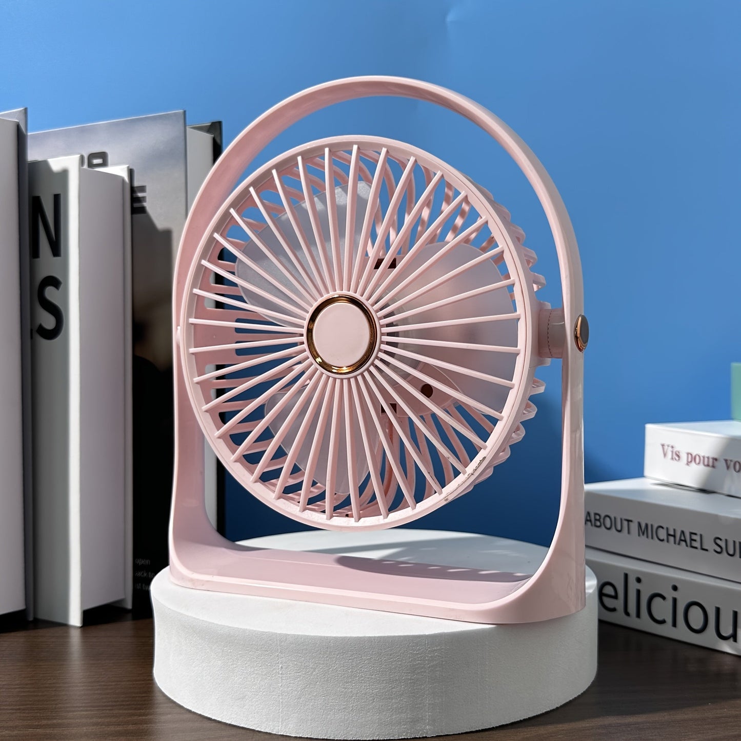 Stay cool anywhere with the JKUOO Portable USB Desk Fan. Featuring 5 speeds and 360° silent operation, this high-velocity fan is powered by a rechargeable lithium battery for indoor and outdoor use. Made of durable plastic, this table fan includes button