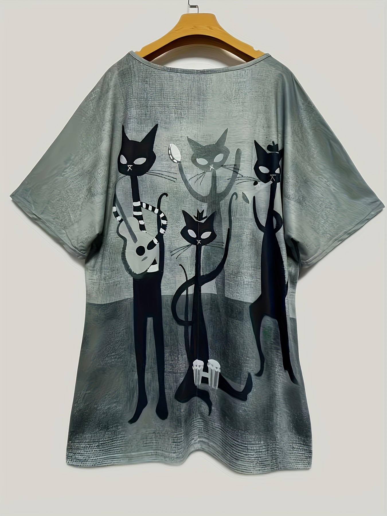 Women's oversized V-neck t-shirt with elegant cartoon cat print, made of 95% polyester and 5% elastane. It has medium stretch, short sleeves, and is made of all-season knit fabric.