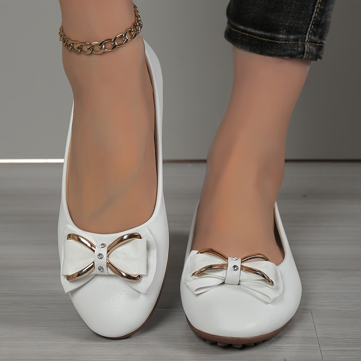 Casual flats for women with bow and rhinestone detail, round toe comfort, slip-on style, solid color.