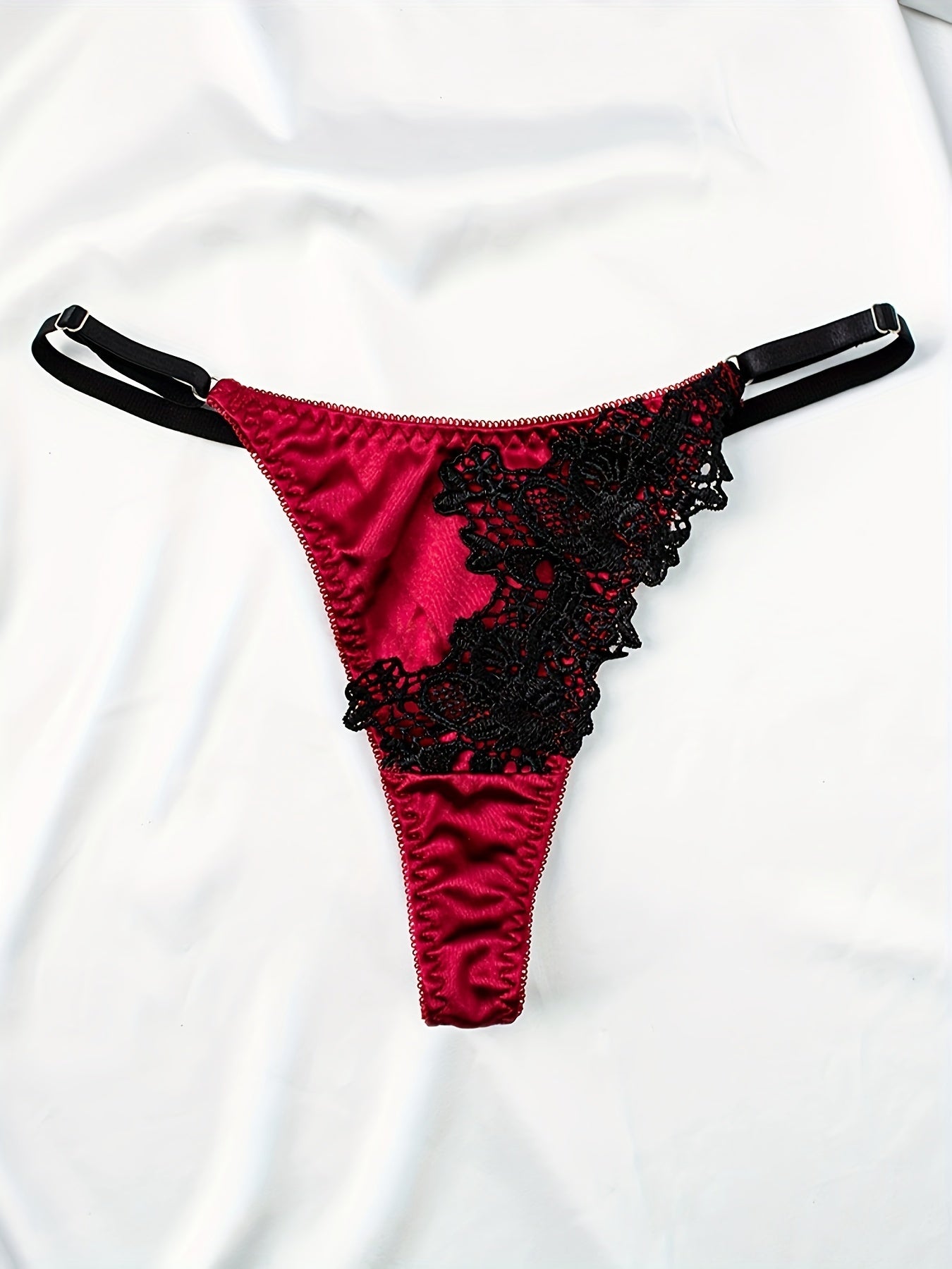 Embroidered satin lingerie set with garter belts.