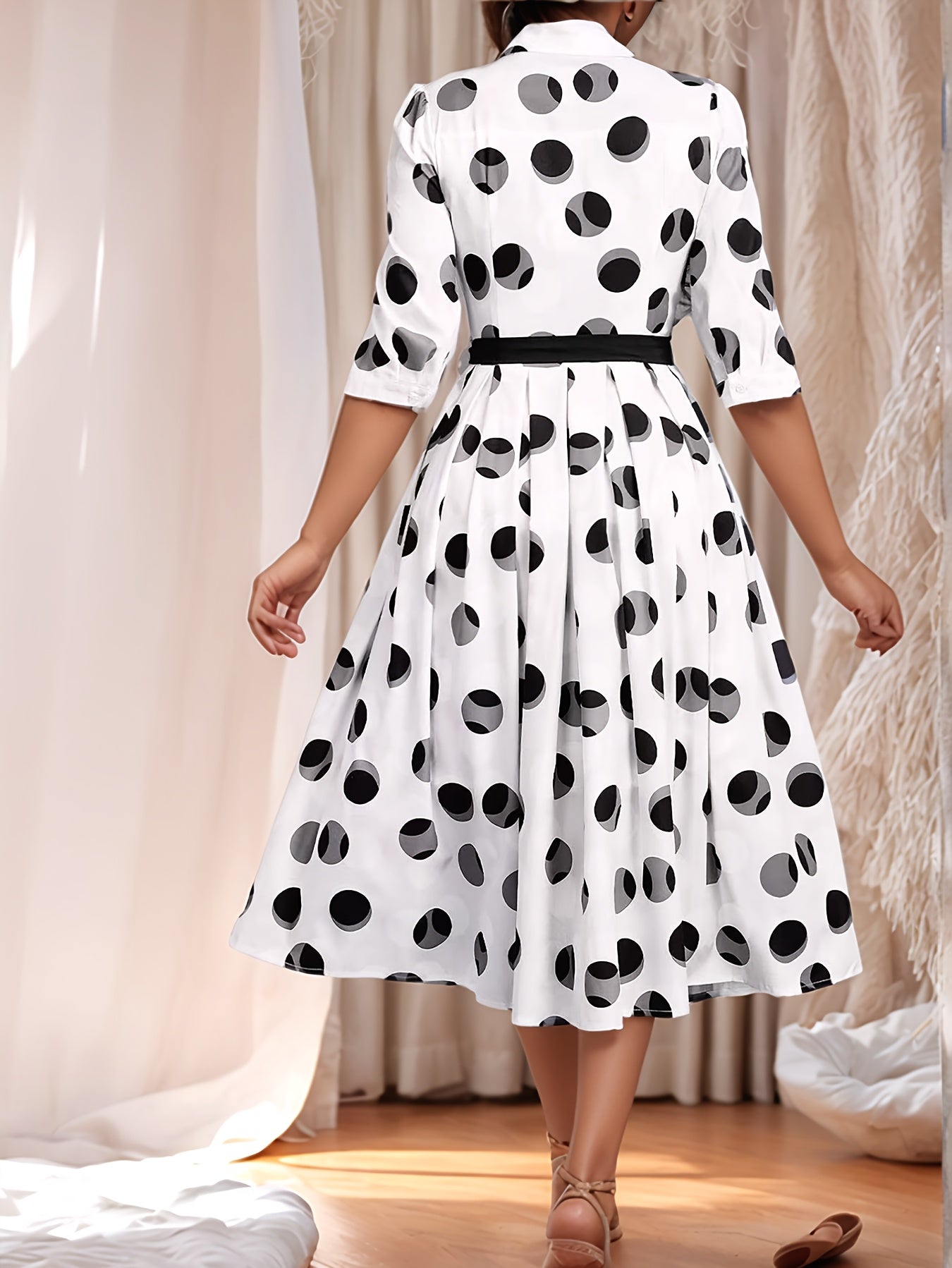 Vintage-inspired midi shirt dress with belt, polka dot print, collared design, and flared skirt in machine washable polyester.