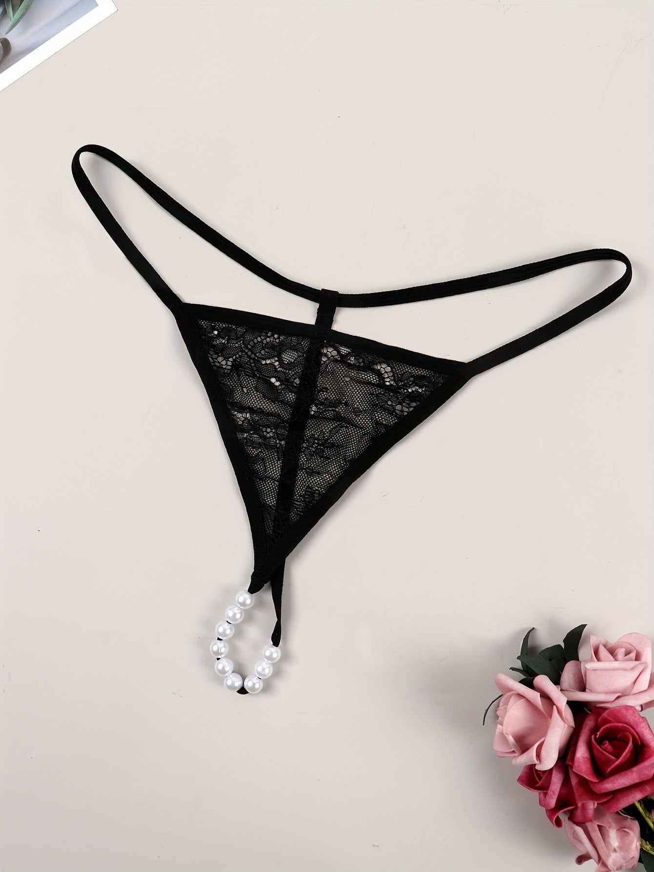 Sexy lace thong embellished with beads, transparent design for women.