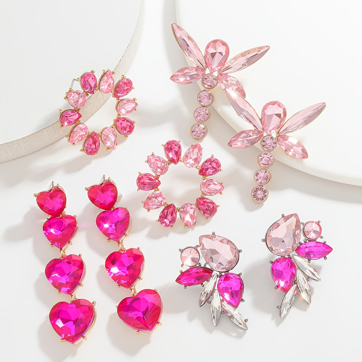 Add a touch of sparkle this Valentine's Day with our Pink Heart & Crystal Winged Drop Earrings. Featuring an elegant bling style, these earrings are made of Zinc Alloy with Stainless Steel Posts, perfect for weddings, parties, and gifts. The Round