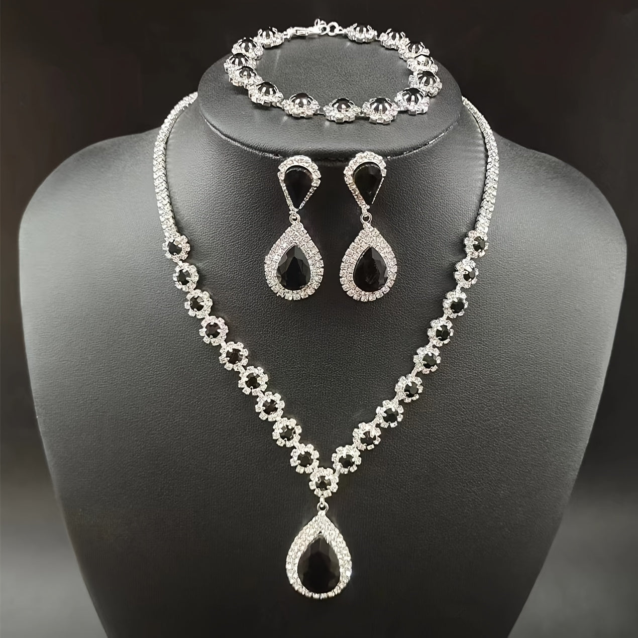 A set of three jewelry pieces for brides and ladies, including one necklace, one pair of earrings, and one bracelet, all featuring flower drop designs. Perfect accessories to complement any dress.