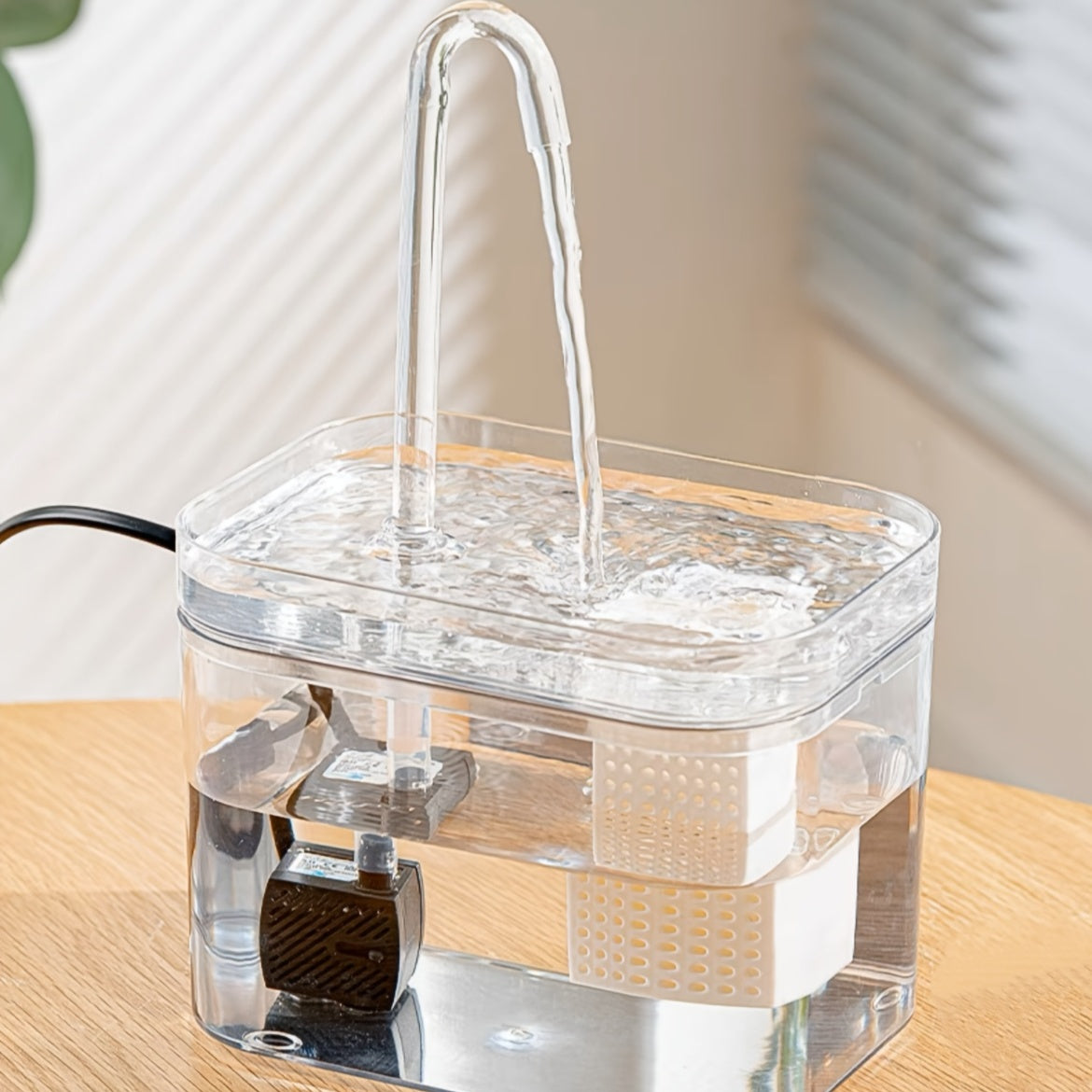 Transparent USB-powered automatic pet water fountain for indoor dog and cat hydration.