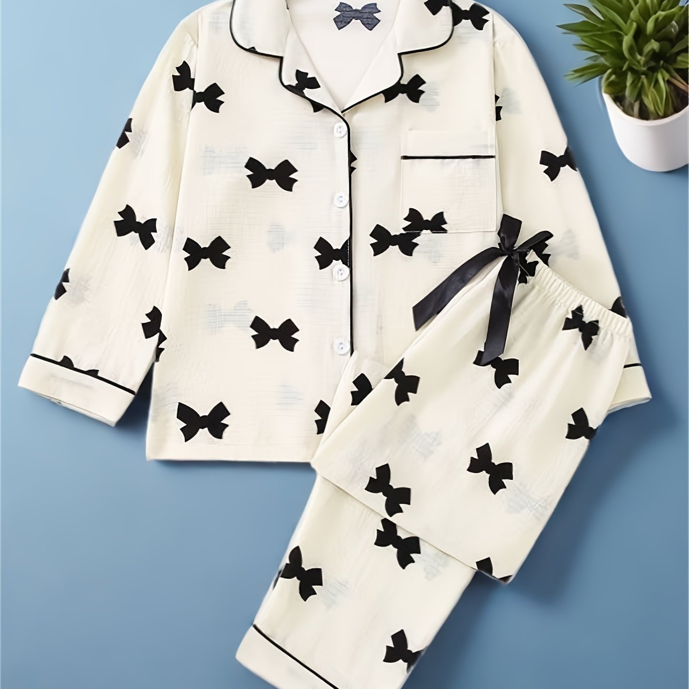 Spring and autumn girls' pajamas set with colorful long-sleeved top and long pants. Casual, cute, and comfortable with simple button and bow design on pants.