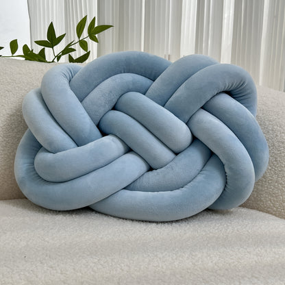 Knotted throw pillow for home decor, suitable for bed or sofa.