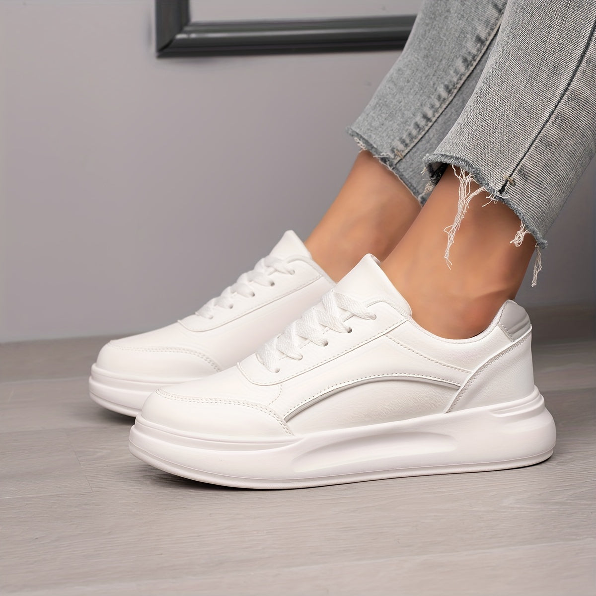 Women's white skate shoes with round toe, lace up closure, and low top flat design. Comfortable for casual wear and sports.