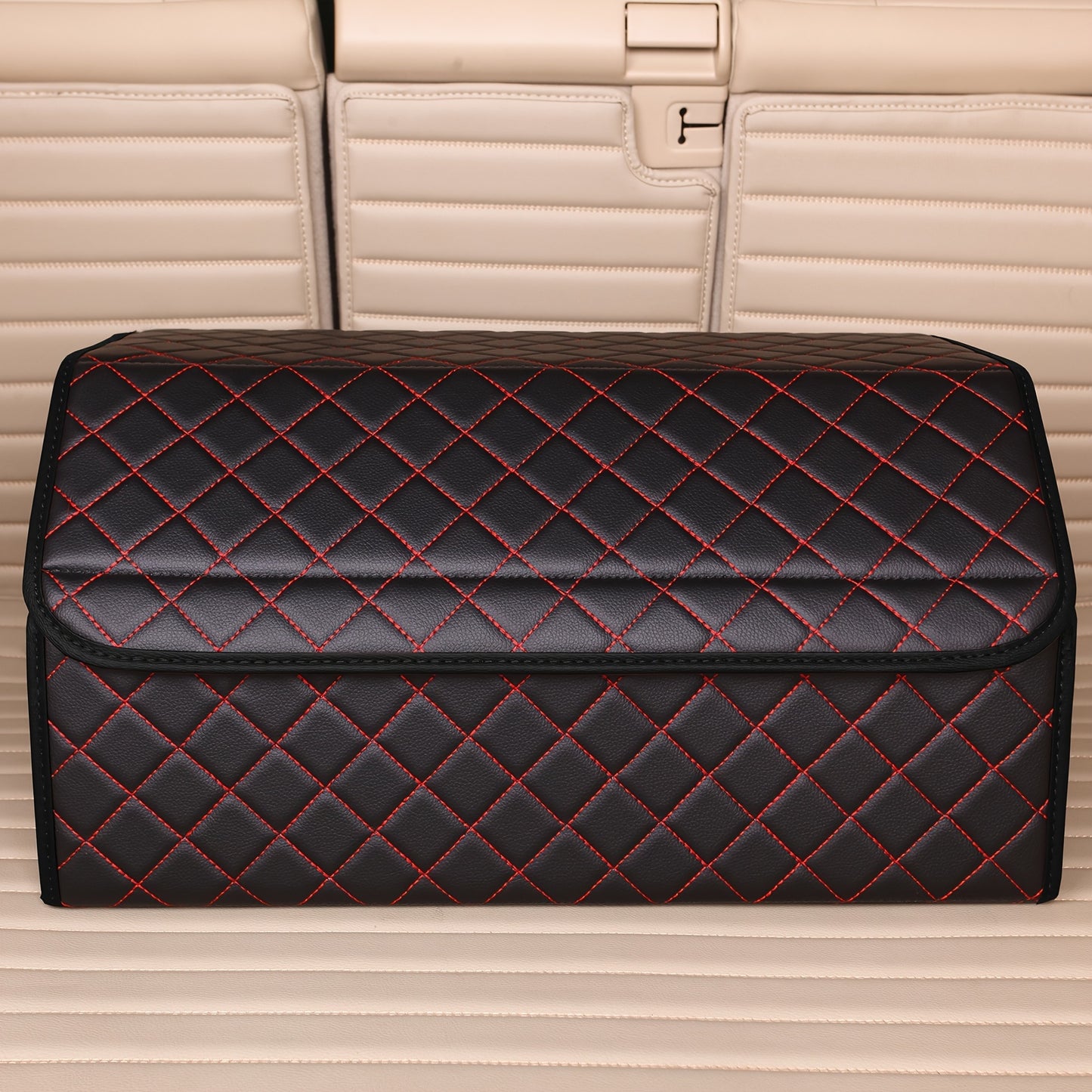 Car trunk organizer made of premium PU leather with diamond stitching and red accents, collapsible and multi-compartment storage box for cars, trucks, and SUVs.