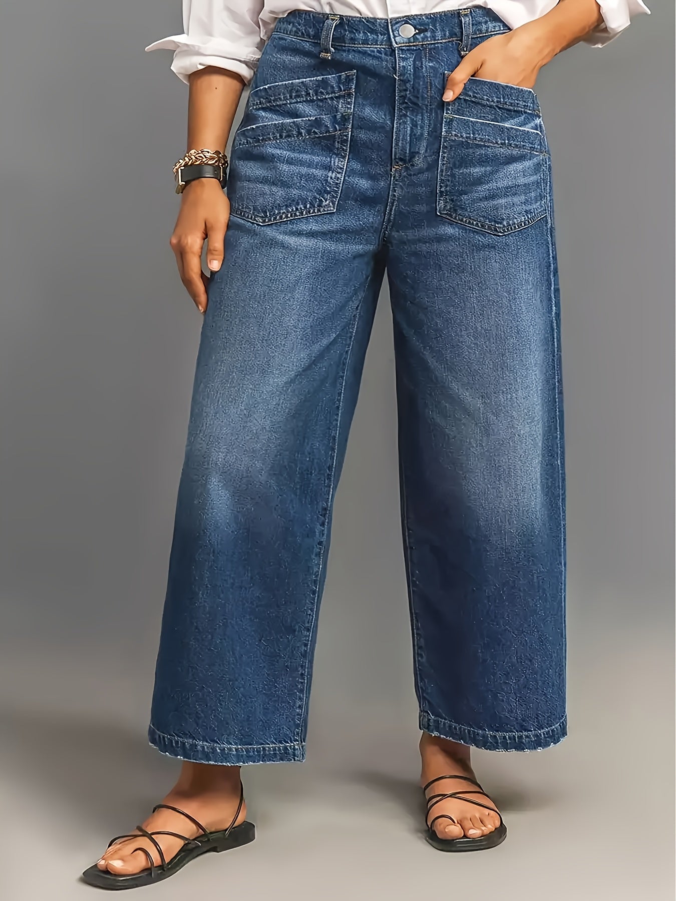 Wide leg high-waisted denim jeans for women in soft blue cotton with slant pockets, loose fit, and mid-rise. Comfortable for all seasons.