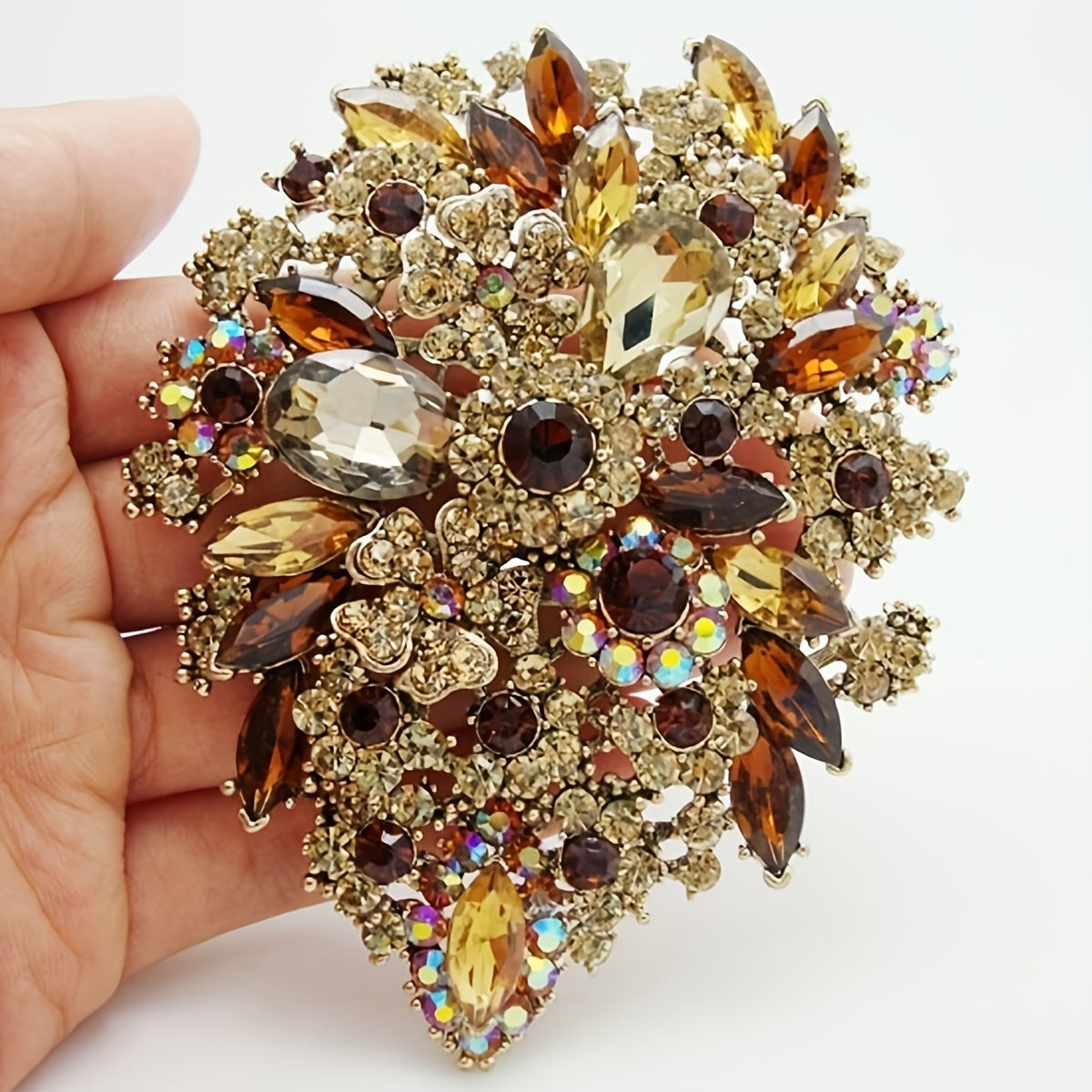 Trsince Brand offers an elegant and luxurious rhinestone brooch pin featuring an irregular shape and gold plated sparkly gemstones, perfect for any woman looking for a unique and stylish accessory.