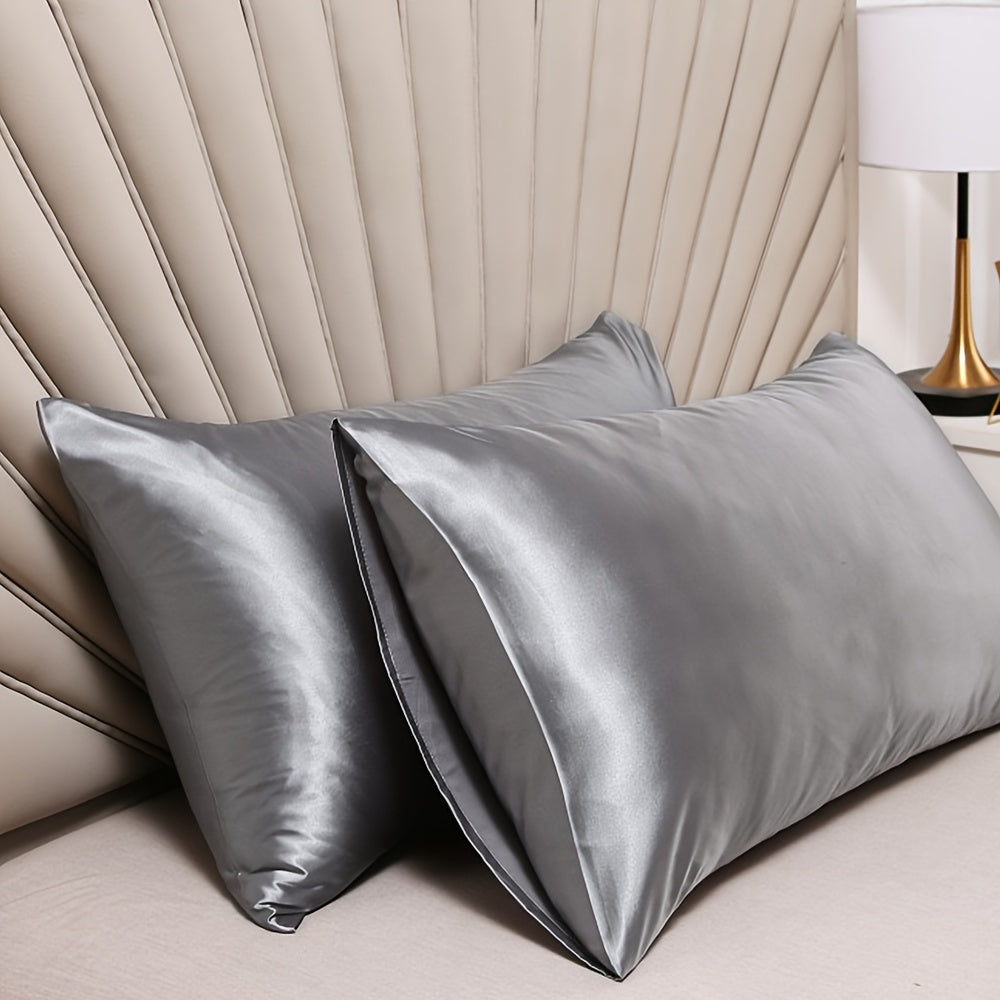 Two-pack of luxurious silky satin pillowcases, made from ultra soft smooth polyester with an envelope closure design. Available in solid colors, these machine washable pillow covers are lightweight at 80-85gsm, providing cooling comfort for hair and