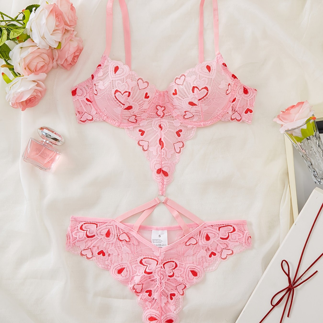 Pink heart-embroidered adult lingerie set made from polyamide and elastane blend, suitable for adults.