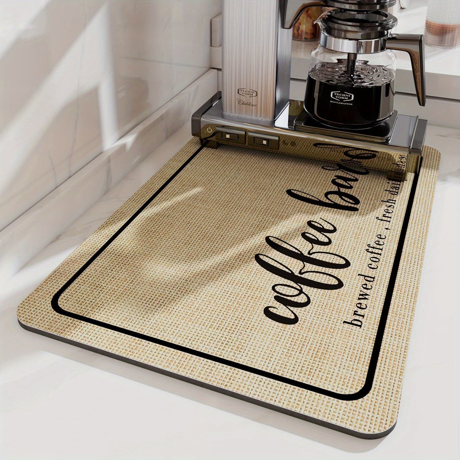 Keep your kitchen clean with the "Coffee Lover" Quick-Dry Coffee Mat, designed with hidden stain absorption and a rubber backing. Perfect for your kitchen counter or coffee bar, this mat is ideal for use with espresso machines and coffee mugs.