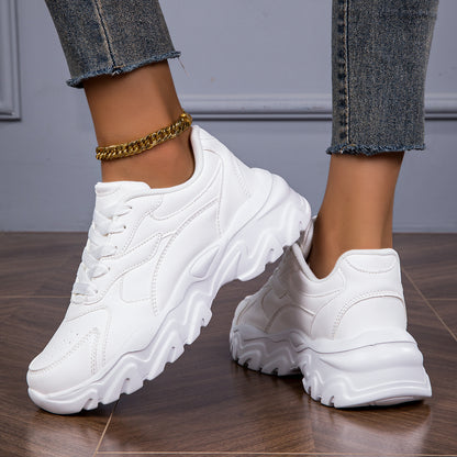 Women's white low-top lace-up sneakers for casual walks and shopping.