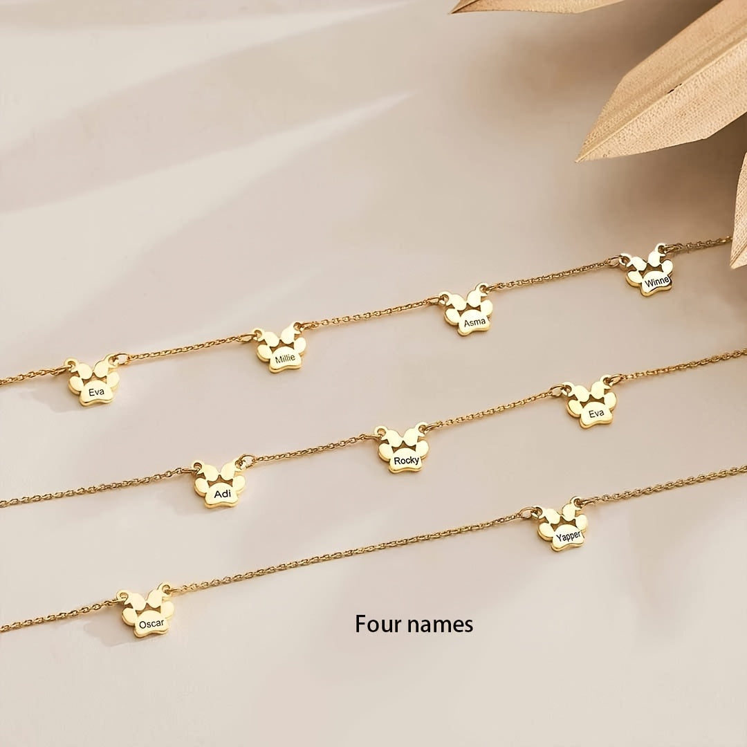 Get your hands on this exquisitely crafted 18K gold-plated copper pet paw necklace, featuring custom engraving of your pet's name and claws design. The cute and simple script and numeric symbols make it a stylish accessory perfect for everyday wear or