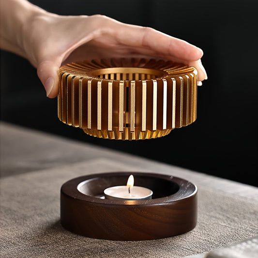 Compact metal heating base for home and hotel, ideal for teapots and fine cups, powered by an elegant candle for a warm tea experience.