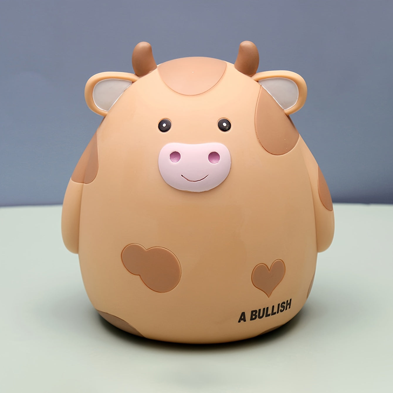 Cute cow-shaped penny bank, perfect for saving money and as a creative gift for birthdays and Christmas. Made of non-waterproof PVC with latch closure, ideal for desk decor.