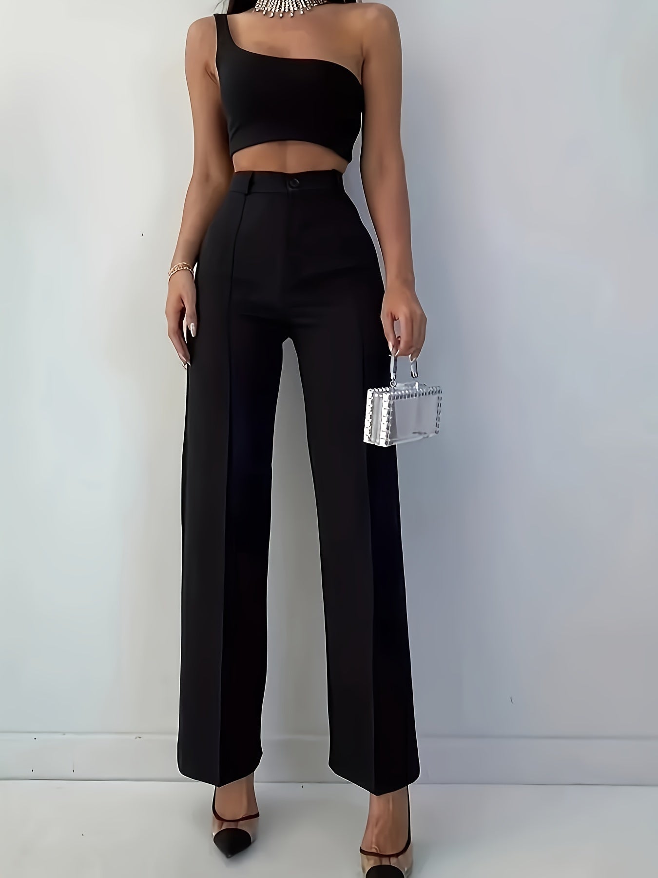 Stylish women's black pants, high-waisted, sleek polyester material, machine washable - suitable for professional and social occasions.