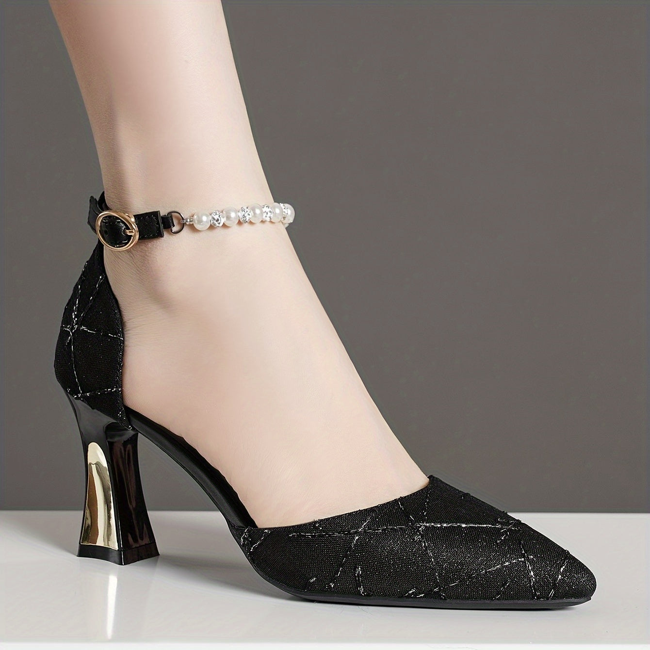 Faux pearl embellished high heels with elegant pointed toe and buckle strap.