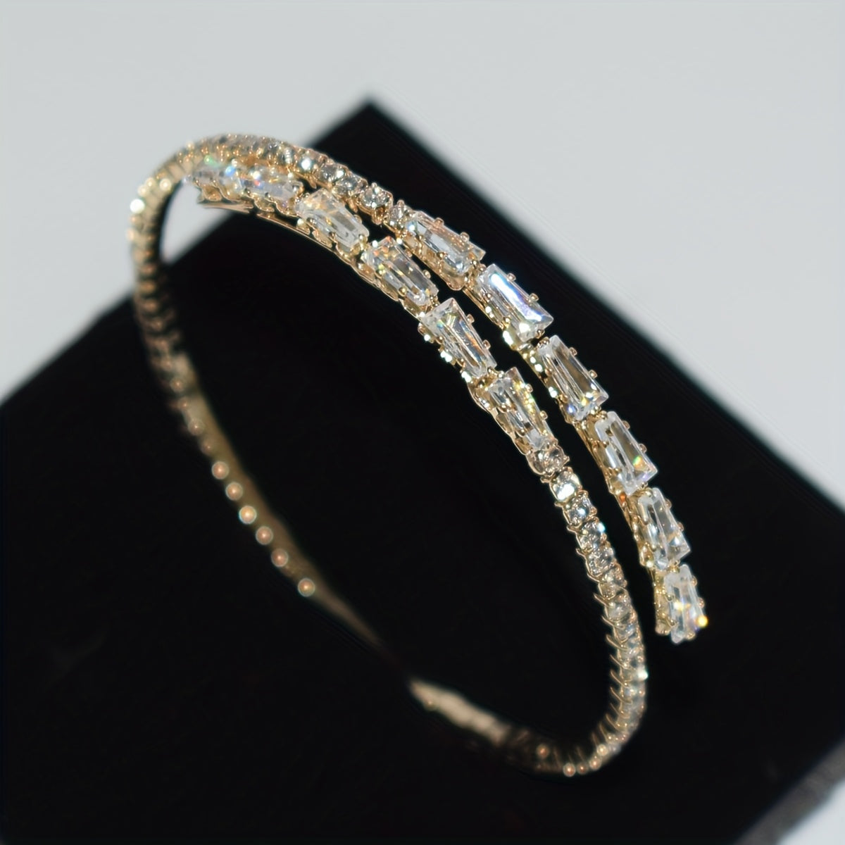 Elegant silvery-plated bracelet with cubic zirconia in classic single row design for weddings and everyday glam.