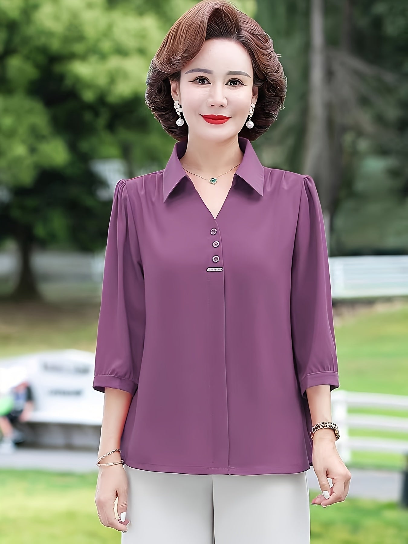 Stylish purple chiffon blouse for women with 3/4 sleeves, slimming fit, and decorative buttons. Made of lightweight polyester-elastane blend, perfect for spring, summer, and fall. Features