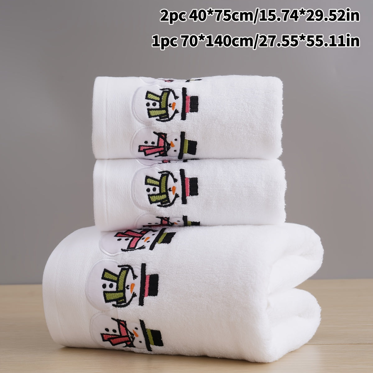 Christmas-themed towel set with embroidered snowman design. Includes 2 towels and 1 bath towel, ideal for couples' bathroom essentials and holiday gifts. Made of 100% cotton.