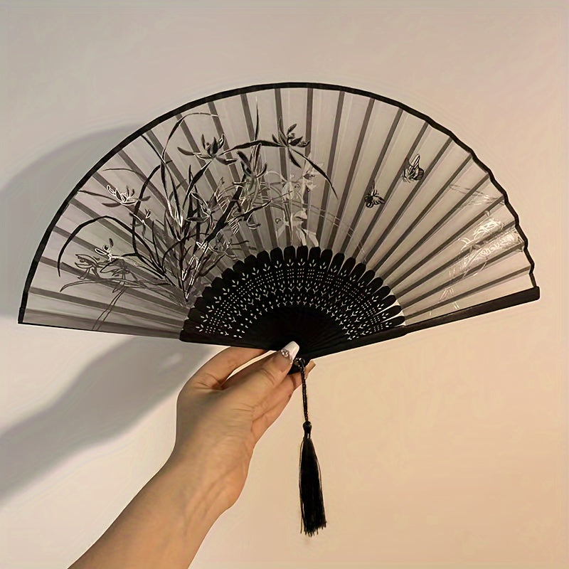 Asian-inspired bamboo hand fan with plant design - perfect for home decor, dance, or as a gift.