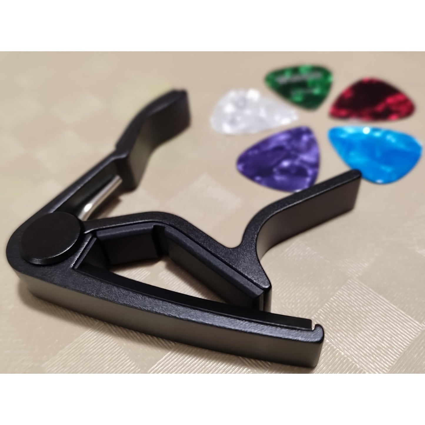 Guitar capo with 5 picks and quick change clamp for acoustic and electric guitars. Includes bonus guitar picks.