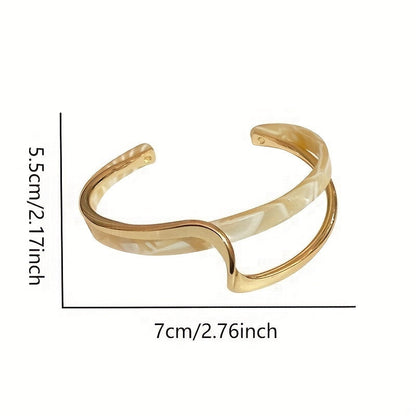 Wave-shaped cuff bangle with faux pearl inlay, featuring a minimalist style in 18K gold plating, ideal for women's jewelry collection