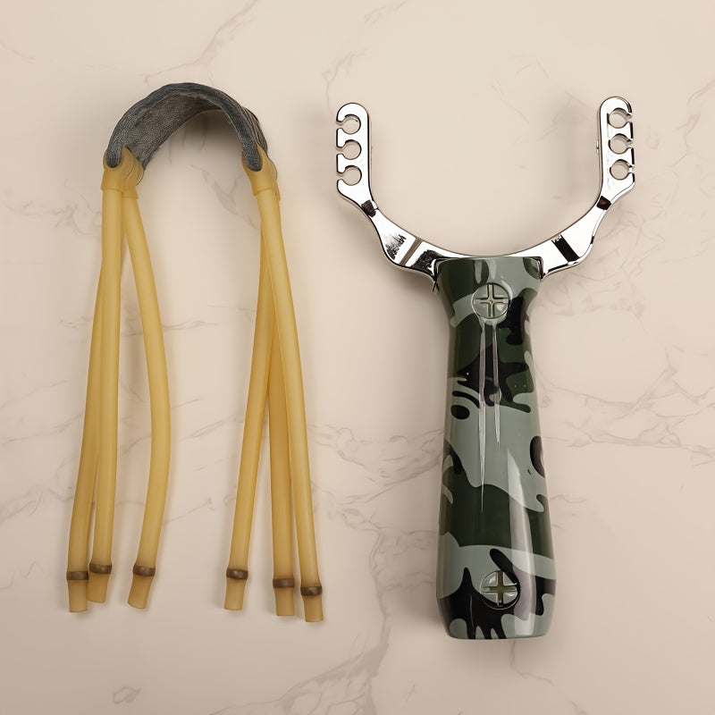 One alloy slingshot with plastic handle in camouflage design, ideal for outdoor shooting with wooden texture and three rubber bands.