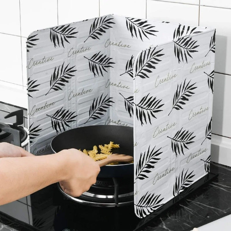 Kitchen stove baffle made of foldable aluminum foil featuring a tropical leaf pattern. This splash guard and cooking safety screen is perfect for deep frying and adding a touch of style to your kitchen decor. Use it as stove top protectors for added