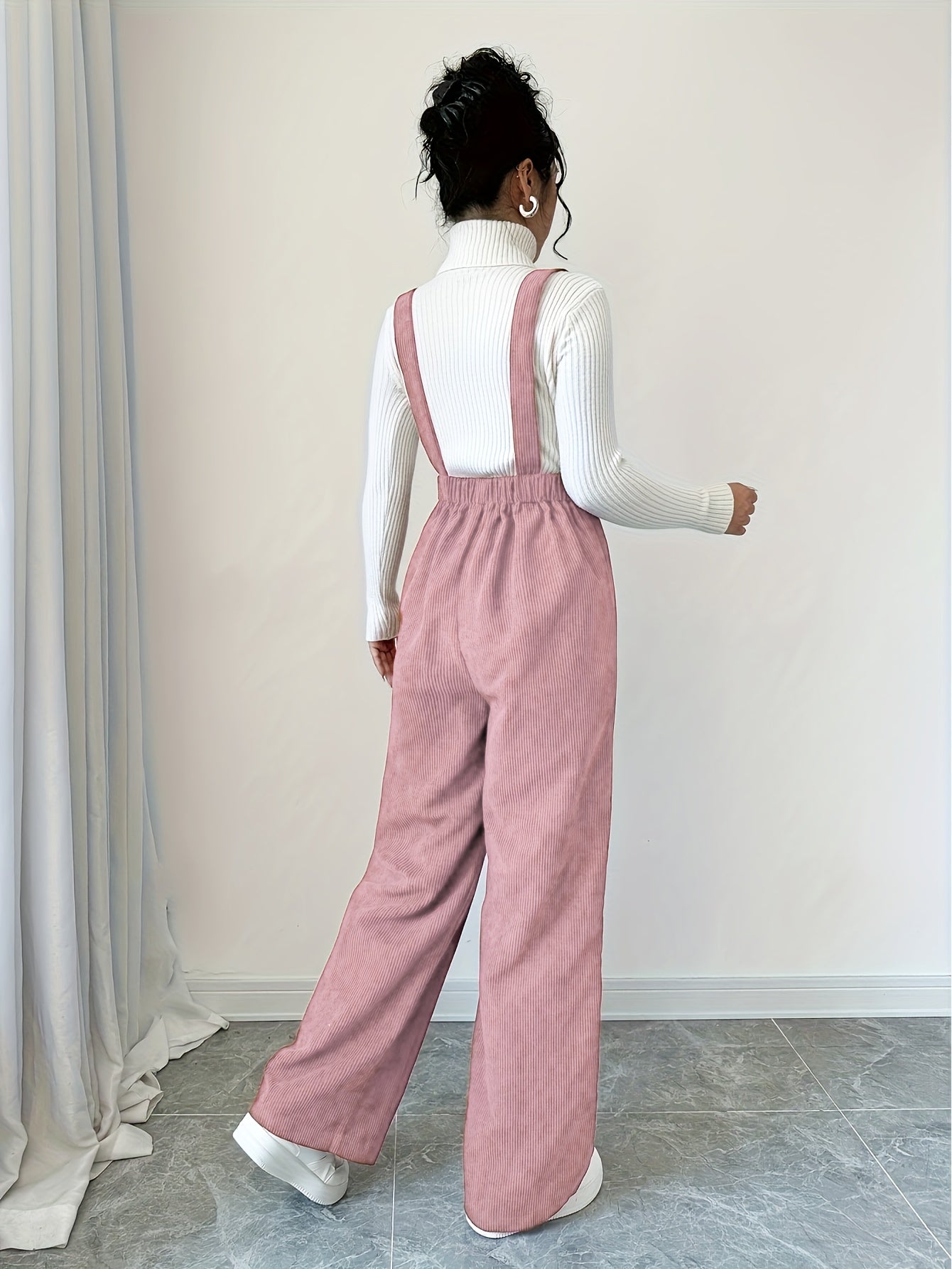 Spandex polyester jumpsuit for women with wide straps and button details, perfect for fall and winter.