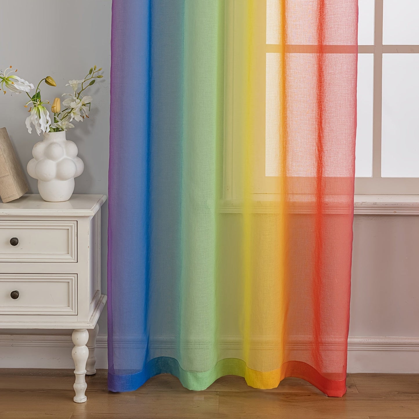 Set of 2 Modern Rainbow Stripe Sheer Curtains made of 100% Polyester, with Rod Pocket design for easy hanging in Living Room, Bedroom, or Office. These Decorative Unlined Panels can be Hand Washed and are suitable for all seasons. Enjoy the Transparent